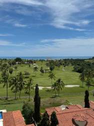 View of fairways palm trees and Pacific Ocean from balcony PH Las Olas II at Vista Mar Resort Panama