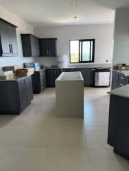 Stylish kitchen with dark cabinets center island ocean views Las Olas II Panama