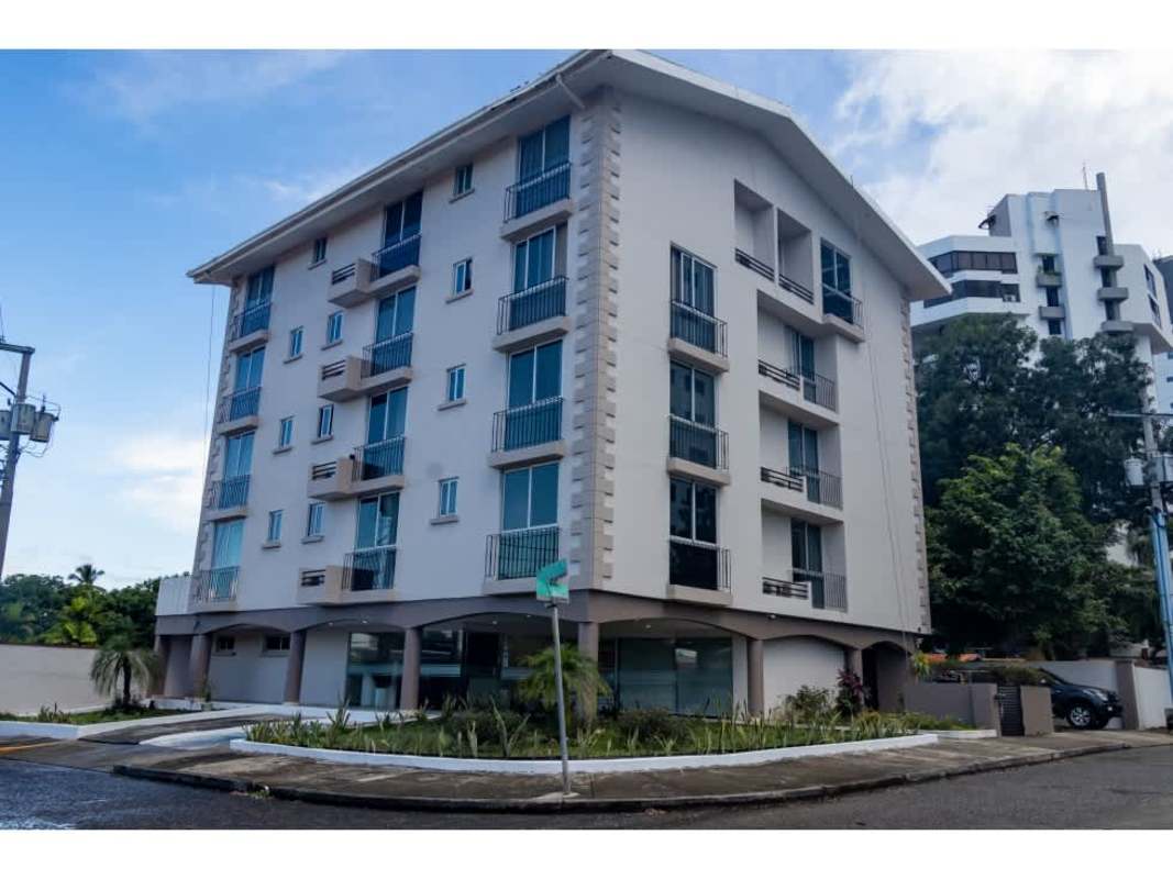 Modern dining area with colorful chairs and city view in PH Coral Tower Coco del Mar