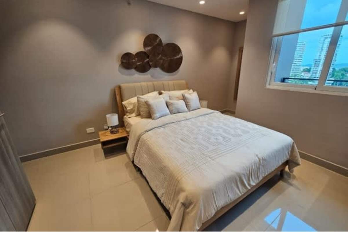 Bedroom with large window, city skyline view at Bella Vista 50 Tower Panama City