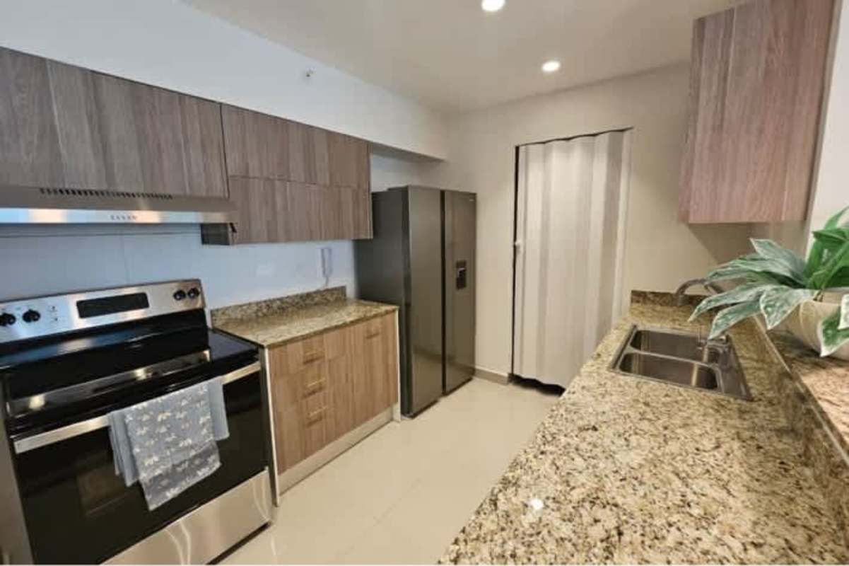 Modern kitchen with granite countertops, stainless appliances in PH Bella Vista 50 Tower Panama City