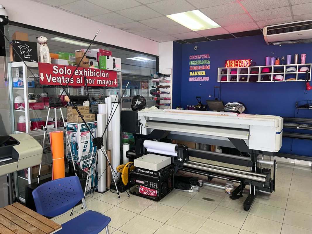 Print shop interior featuring plotter, merchandise shelves, signage San Miguelito Panama