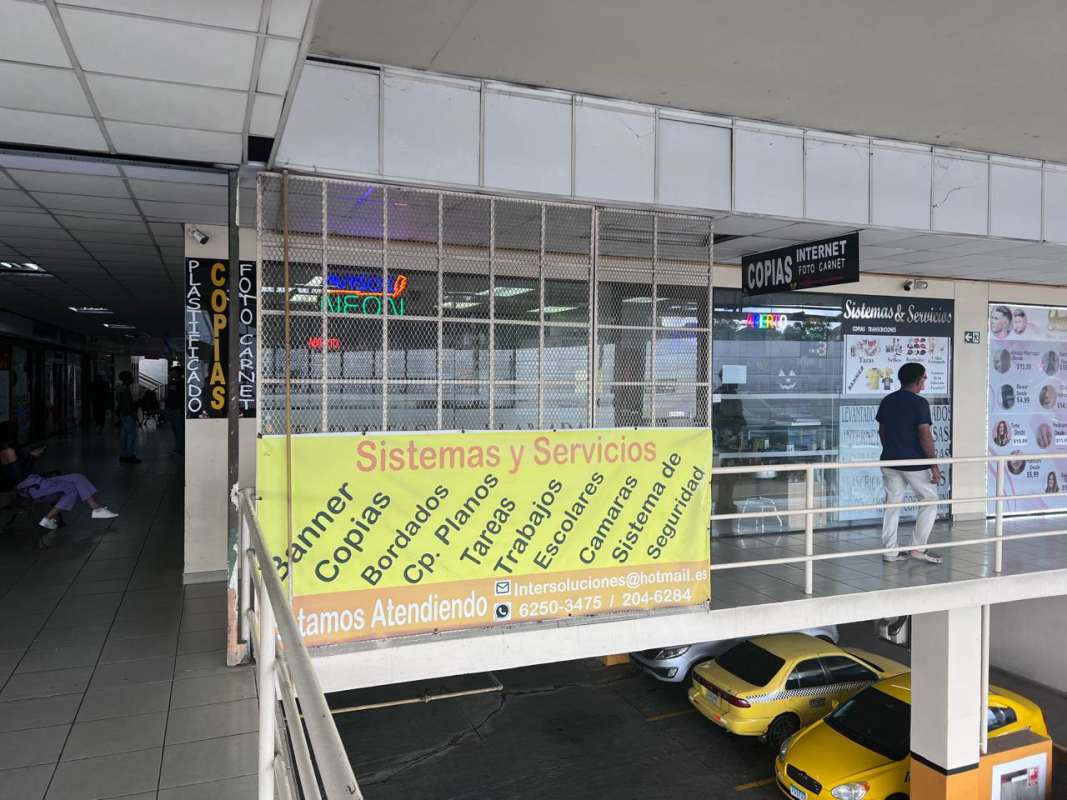 Exterior of San Miguelito commercial center with copy shop signage and parking Panama City
