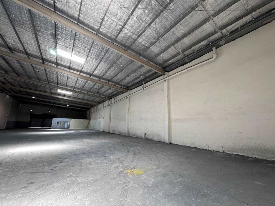 Empty wide warehouse floor with concrete surface and insulated metal roof Costa del Este Panama