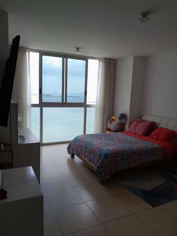 Modern bedroom with large windows, ocean views and minimalist decor in PH BICSA Tower