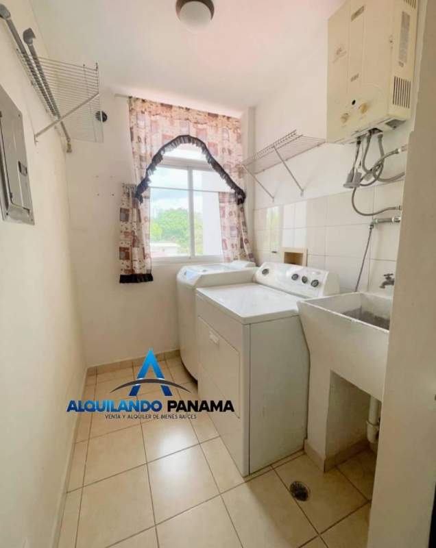 Galley kitchen with tile floors, cabinetry, refrigerator, gas stove, ceramic backsplash in Betania Panama
