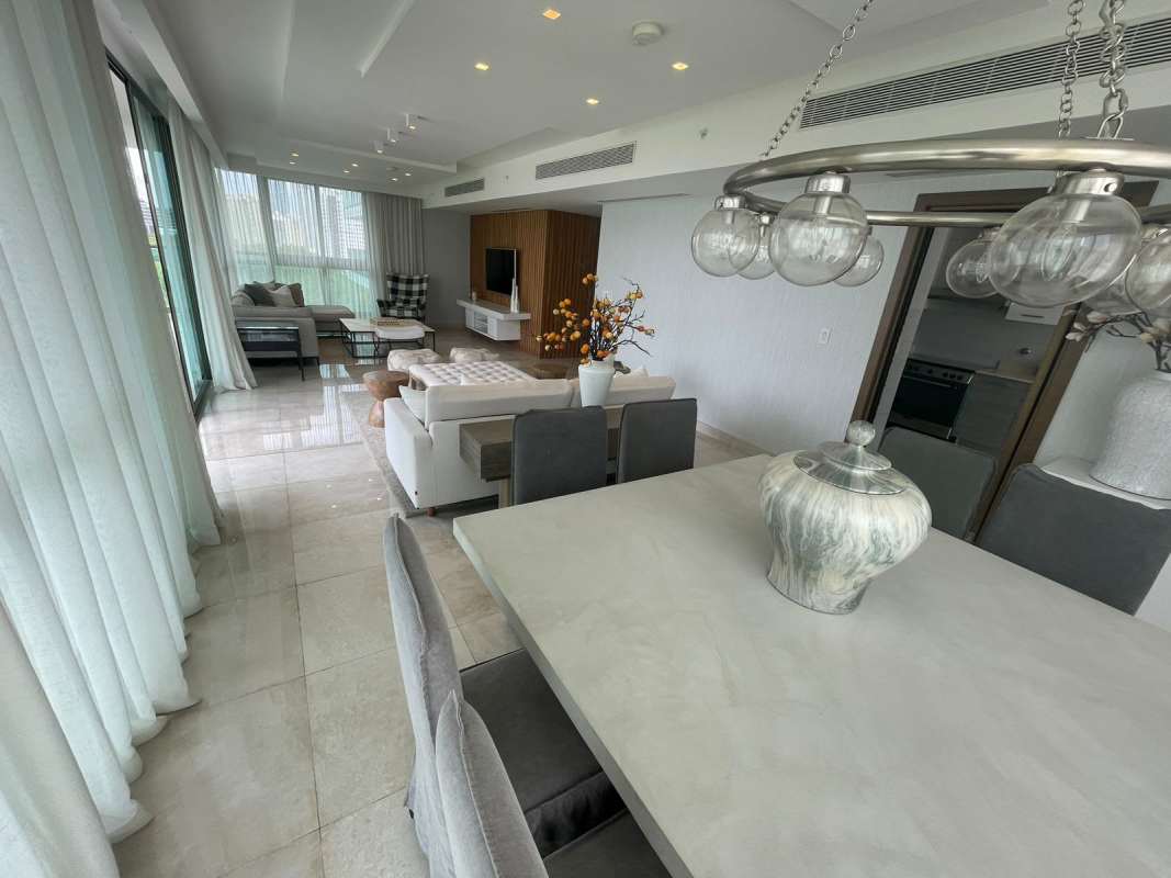 Open living dining space with city view and floor-to-ceiling windows at PH Park Lane Costa del Este