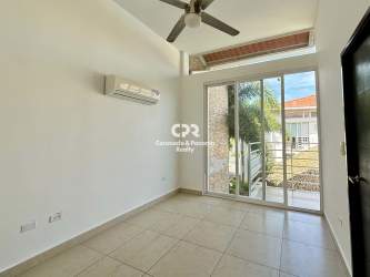 Living room with white tile flooring, ceiling fan, AC and balcony at Paraiso Village VIP in Coronado Panama