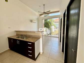 Kitchen area with granite countertop, breakfast bar and tile floors in apartment Coronado Panama