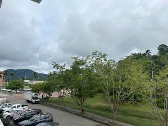 Modern kitchen with granite countertops, dark cabinetry, and stainless steel appliances in PH Soleo Panama