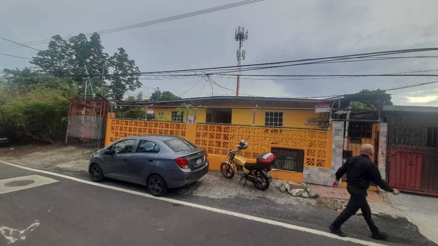Yellow-painted building view with tiled walkway and gated entrance Ciudad Radial Panama rental