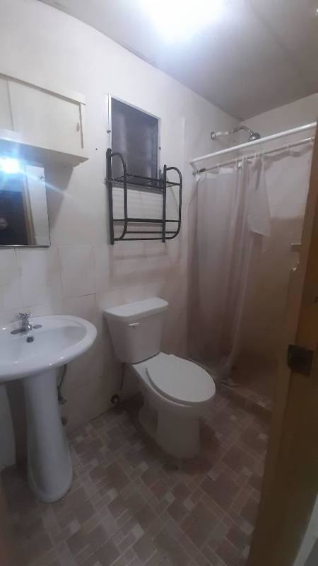 Bedroom with split AC, wall mirror, attached bathroom in Ciudad Radial apartment rental Panama