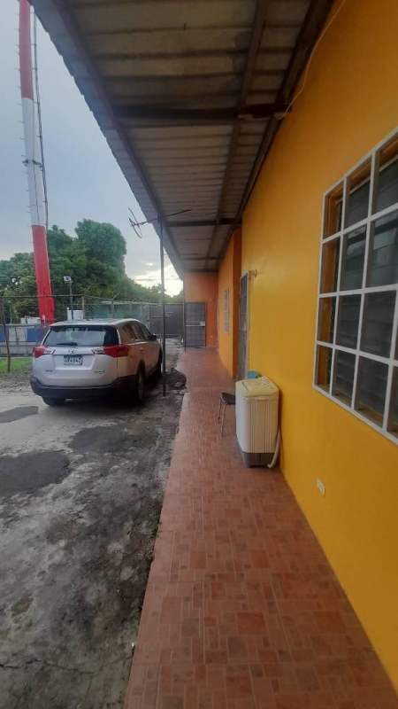 Internal hallway with yellow walls white grid ceiling tiled floor Ciudad Radial apartment rentals Panama