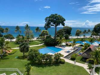 Dining room with glass table and beach views at PH Balboa 2 Bijao Panama