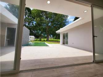 Spacious living dining area with tile floors and large windows in Coronado Golf Club house Nueva Gorgona Panama