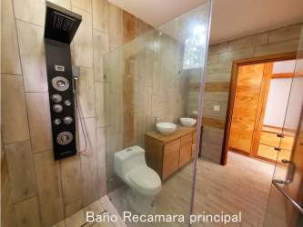 Spacious master bedroom tile floor large window built-in closet in Coronado house