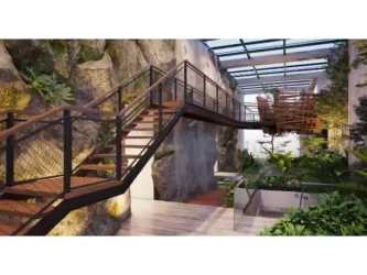 Atrium with staircase and lush greenery at PH MidTower Coco del Mar