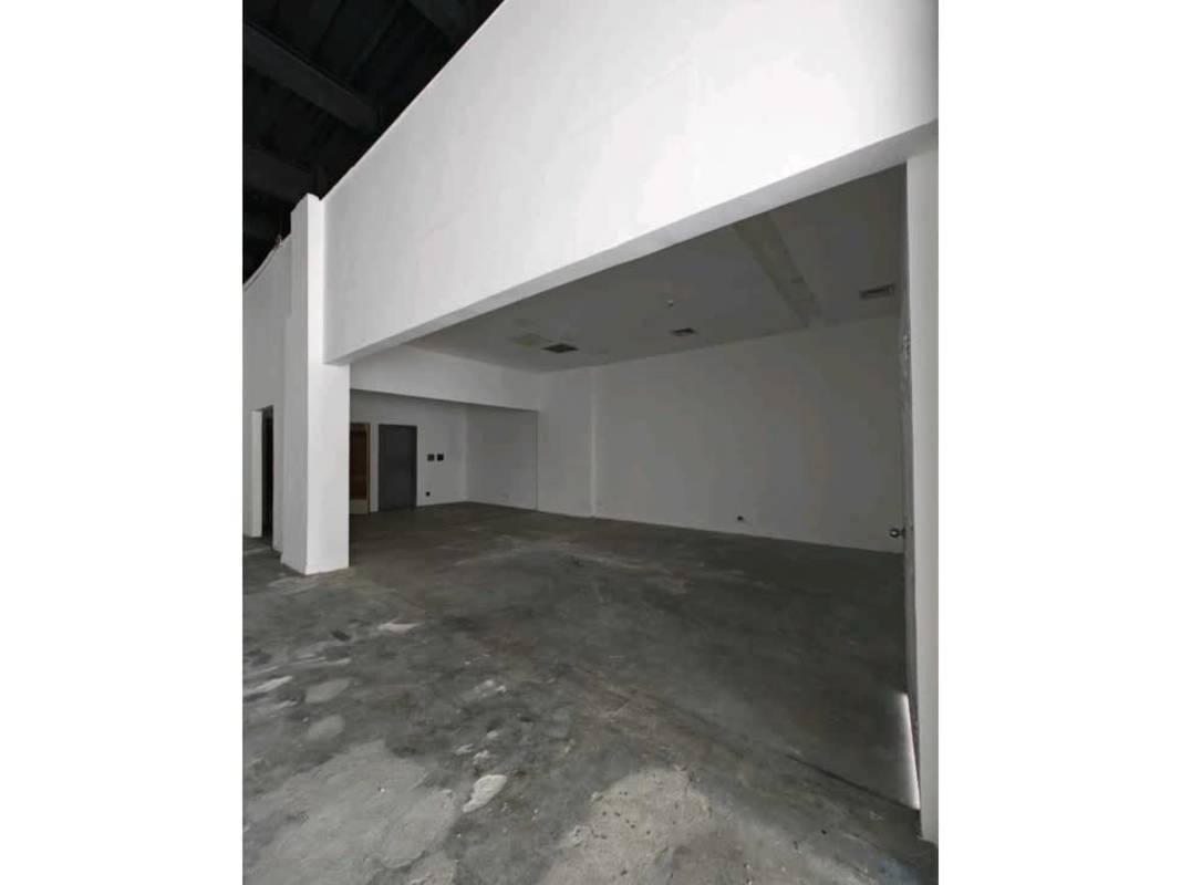 Industrial unfinished open commercial area with concrete floor, white walls, and exposed fixtures in Plaza 76 San Francisco Panama