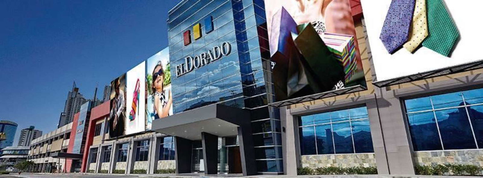 Street view of modern shopping mall with glass facade named El Dorado Panama City