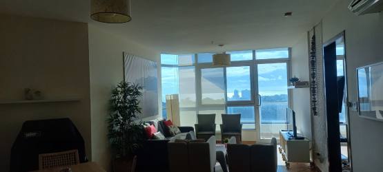 Kitchen area with granite counter open to living space in Coronado Golf condo Panama