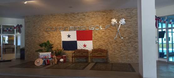 High-rise tower of Coronado Golf Condominium Panama with palm trees