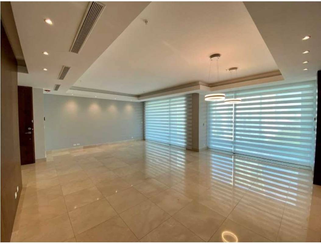 Expansive covered balcony with glass railing ocean and city skyline view at PH Aria Costa del Este