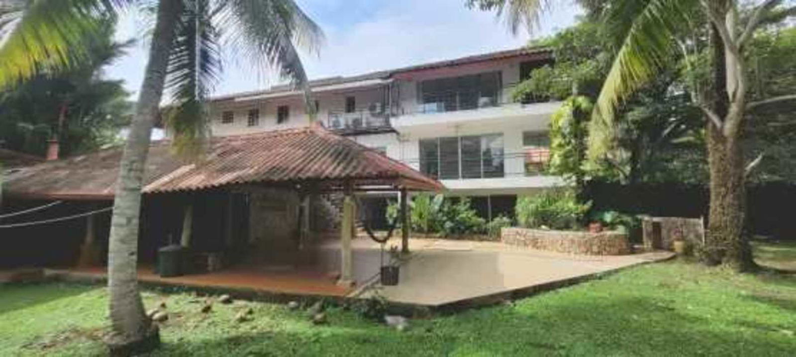 Multi-story home with balconies and lush trees in Albrook Panama