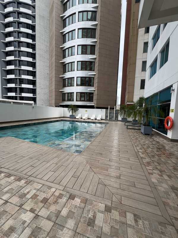 Covered lounge seating area next to swimming pool at PH Miro Via Argentina Panama City