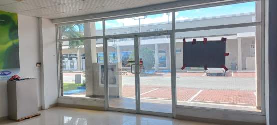 Entry with double glass doors into commercial unit at Plaza Pérgolas Coronado Panama