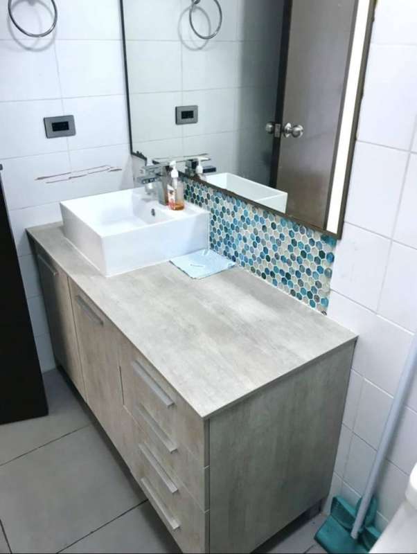 Contemporary bathroom featuring teal tile enclosed shower, vanity and shelf in PH El Cangrejo City Center