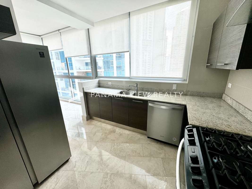 Spacious master suite with floor-to-ceiling windows facing the ocean at PH Grand Tower Punta Pacifica Panama City