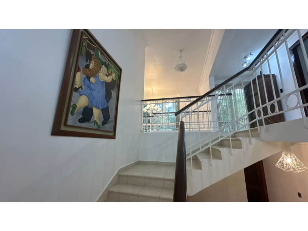 Contemporary living room with balcony view, tiled floors, and ample light in luxury Panama home