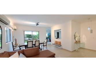 Bright open-concept living dining room with large windows in Palmia house for sale Panama Pacifico