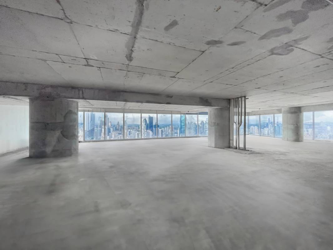 Modern reception lobby featuring digital signage, security turnstiles, blue tile flooring and wood accents at Oceania Business Plaza