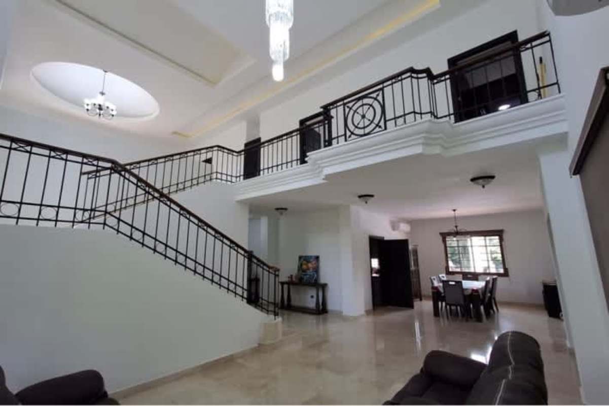 Grand staircase foyer with marble flooring and chandelier Senderos de Caminos de Cruces Panama