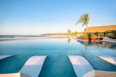 Thatched roof tropical pavilion with bamboo beams outdoor lounge Playa Venao Pedasi