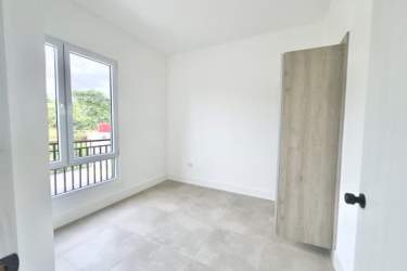 Minimalist bright bedroom with built-in closet and large window Playa Venao Pedasi