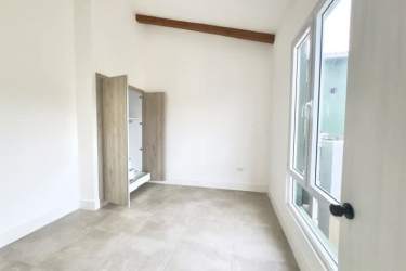 Modern bedroom with built-in closet large ocean-facing window Playa Venao Pedasi