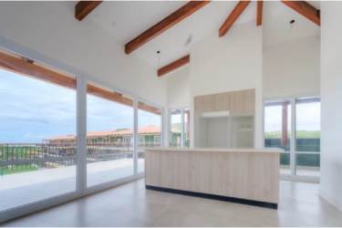 Open concept kitchen with vaulted ceiling, natural wood beams and ocean backgrounds Playa Venao