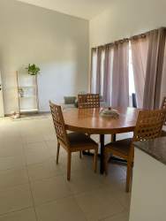 Modern dining room with round table, four chairs, and large window Vista Alegre Panama