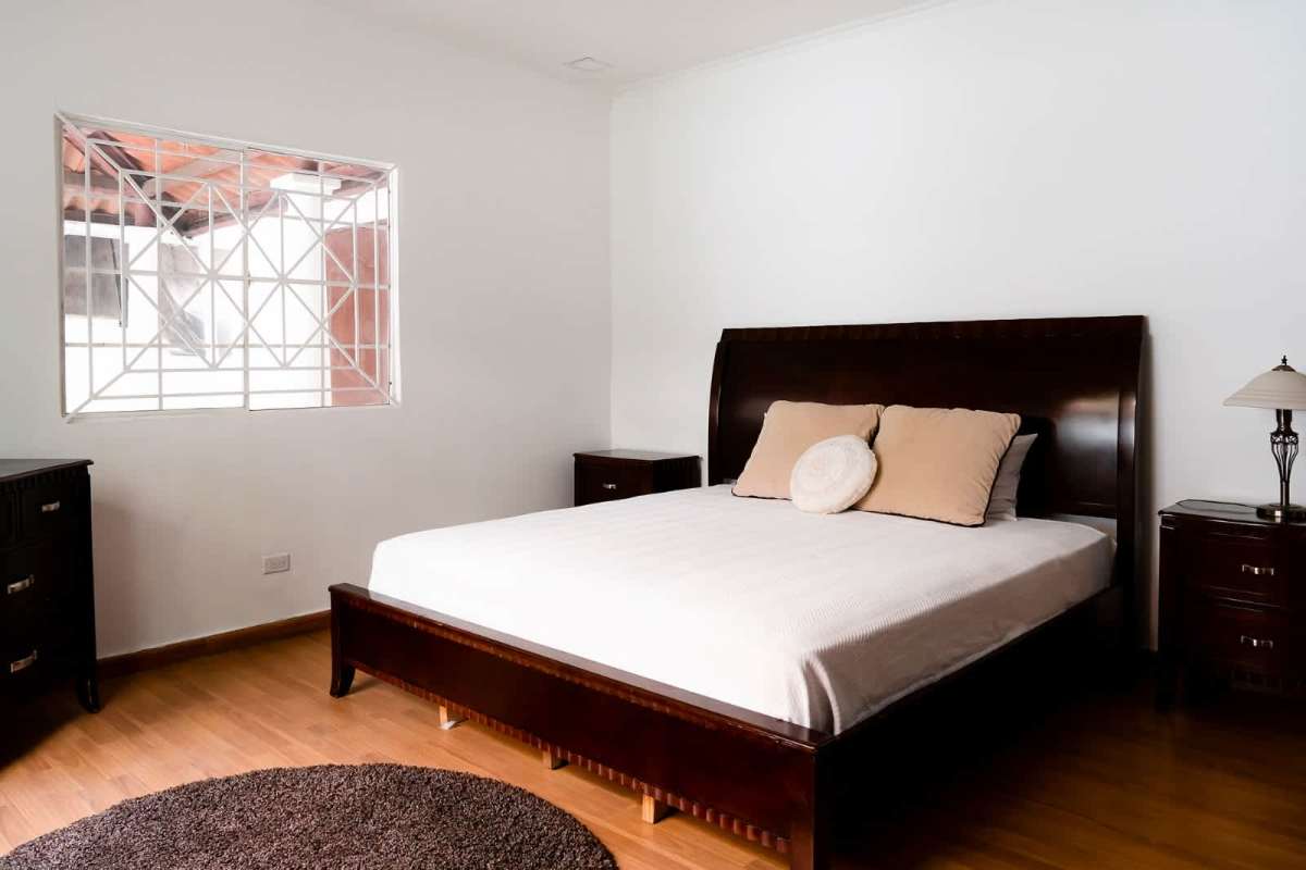 Dining room with wood floor large glass doors decorative ironwork house Obarrio