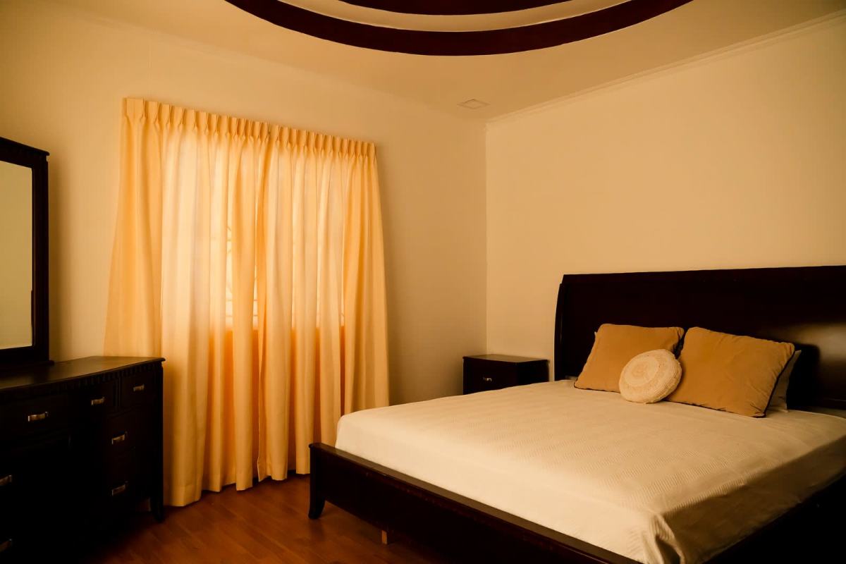 Modern bedroom with large window, dark wood accents for sale Obarrio Panama