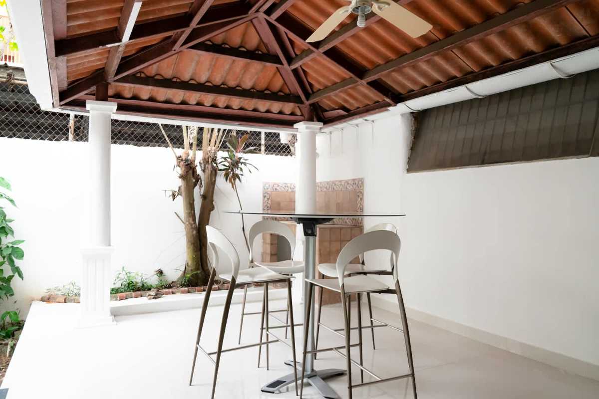 Bathroom with tile shower partition pedestal sink wood mirror frame house Panama