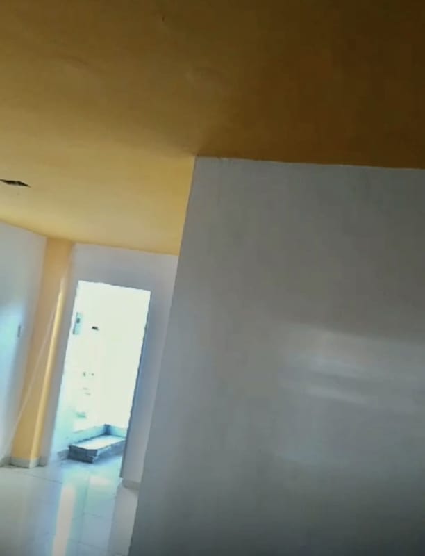 Kitchen with maroon cabinets, double sink, and white tiled walls at PH Las Quintas Brisas del Golf Panama