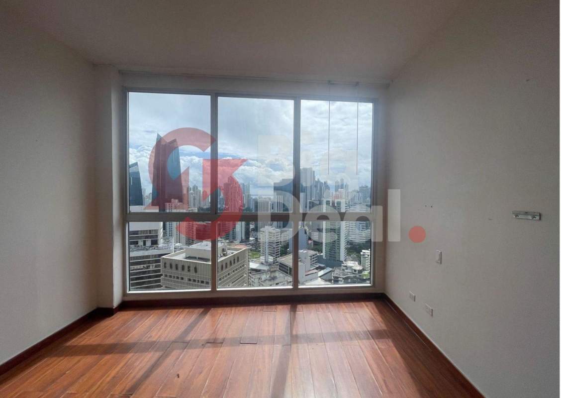 Spacious living room with floor-to-ceiling windows and city skyline view at PH Denovo Panama City
