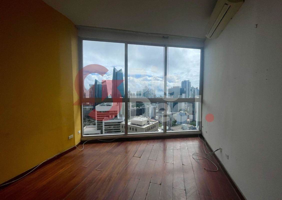 Modern bedroom with wooden floors and city skyline view at PH Denovo Panama City