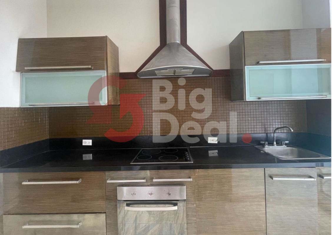 Contemporary apartment kitchen with granite counters, wood cabinets, stainless steel appliances at PH Denovo Panama