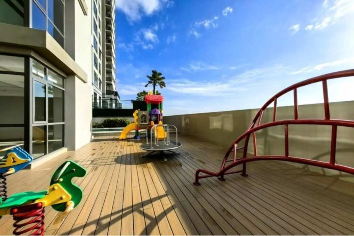 Large balcony with glass railing overlooking golf course and city skyline at PH Albatross Santa María Panama