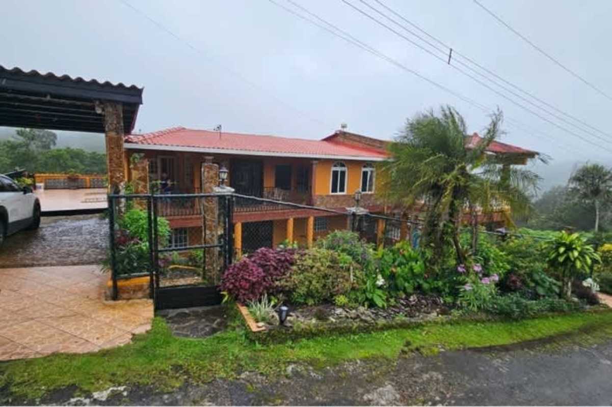 Rustic Mediterranean exterior with balcony, iron railings, garden in Cerro Azul mountain Panama