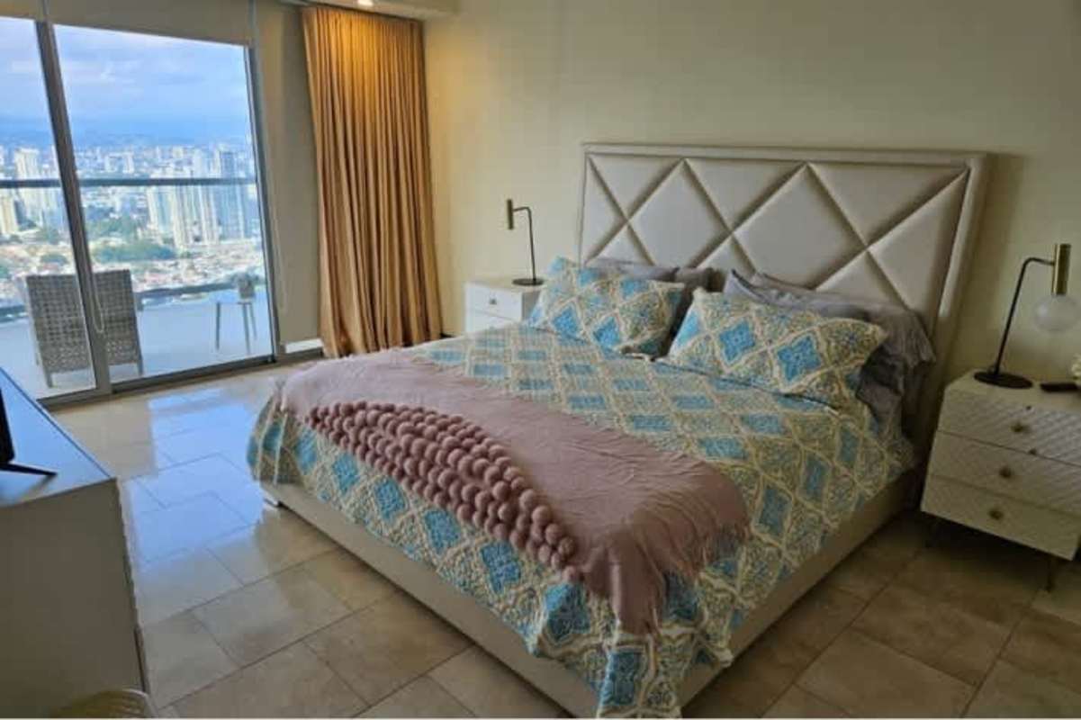 Elegant bedroom with balcony access, city skyline views in luxury PH TOC Punta Pacifica Panama